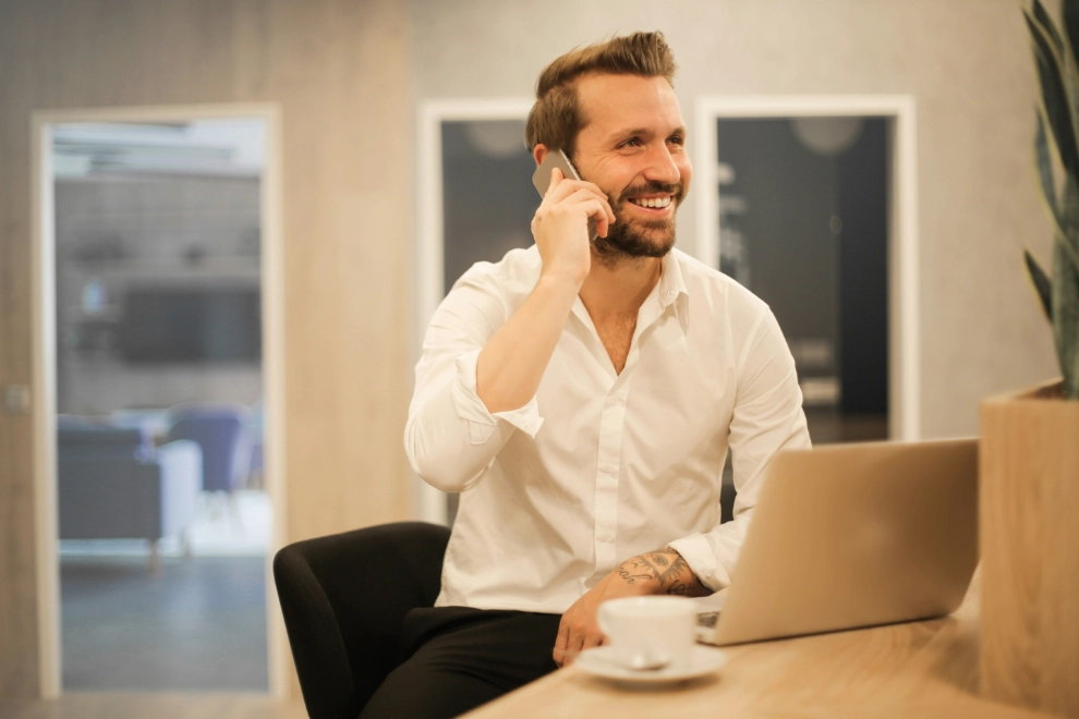 Man using his smartphone sitting on an office chair.